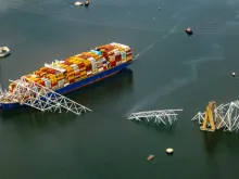 In an aerial view, the cargo ship Dali sits in the water after running into and collapsing the Francis Scott Key Bridge on March 26, 2024, in Baltimore.