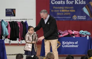 Supreme Knight Patrick Kelly gives the millionth coat to a little girl at Annunciation Catholic School in Denver, Colorado, Knights of Columbus