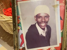 A framed photo of Larry Tutt stands in front of a basket holding red whistles reading "RIP Larry Tutt 2022" following a memorial Mass at the Catholic Information Center in Washington, D.C., Aug. 5, 2022.