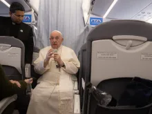 Pope Francis takes questions from the media aboard the papal flight from Hungary to Rome April 30, 2023.