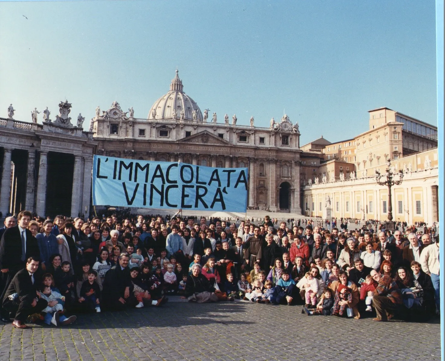 The House of Mary community poses for a photo on Dec. 8, 1994, in St. Peter's Square, the first time they brought their blue banner with the words "The Immaculate Conception will Triumph" to the Angelus with Pope John Paul II. The group has continued to bring the banner to every Sunday Angelus for 29 years.?w=200&h=150