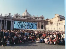 The House of Mary community poses for a photo on Dec. 8, 1994, in St. Peter's Square, the first time they brought their blue banner with the words "The Immaculate Conception will Triumph" to the Angelus with Pope John Paul II. The group has continued to bring the banner to every Sunday Angelus for 29 years.
