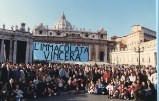 The House of Mary community poses for a photo on Dec. 8, 1994, in St. Peter's Square, the first time they brought their blue banner with the words "The Immaculate Conception will Triumph" to the Angelus with Pope John Paul II. The group has continued to bring the banner to every Sunday Angelus for 29 years. Credit: Comunita Casa di Maria