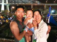 Luke and Tina Nguyen of Seattle with their 14-month-old son, Finn, after the prayer vigil with Pope Francis at Parque Tejo Aug. 5, 2023. The young family attended World Youth Day 2023 in Lisbon, Portugal.