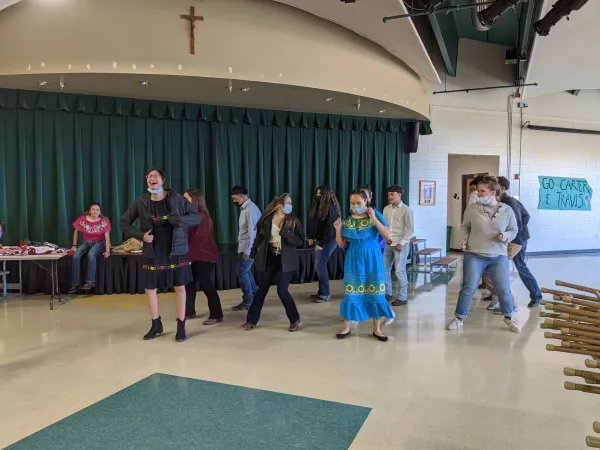 Students from Bishop Machebeuf High School practice a traditional Hispanic dance. Credit: Katherine Candler