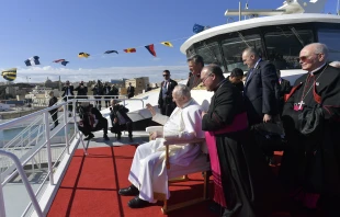 Pope Francis waves to children while he waits aboard a catamaran to depart for the Maltese island of Gozo where would lead a prayer service on April 2, 2022. Vatican Media