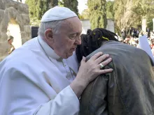 Pope Francis embraces Daniel Jude Oukeguale, who detailed his arduous journey of escaping Nigeria in an effort to be smuggled into Europe, during the pope's visit to an immigration reception center in Hal Far, Malta, on April 3, 2022.