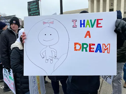 A man holds up a sign while marching outside the U.S. Supreme Court at the March for Life in Washington, D.C., on Jan. 21, 2022. Katie Yoder/CNA