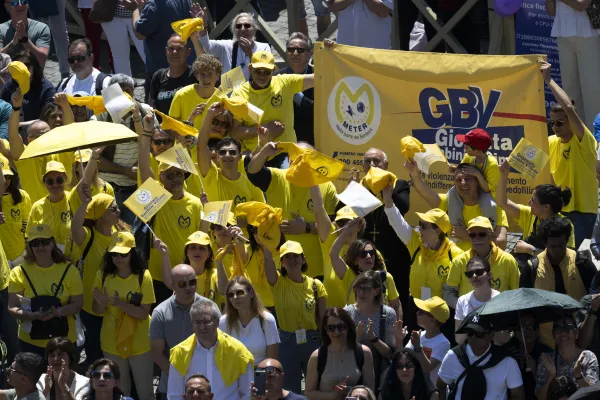 Members of the Meter Association, an organization that works to combat the abuse of minors, wave flags and a banner in St. Peter's Square on May 7, 2023. Vatican Media