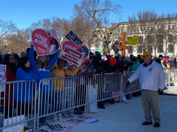 An excited crowd holding pro-life signs begins to form near the March for Life rally stage prior to the rally. Katie Yoder