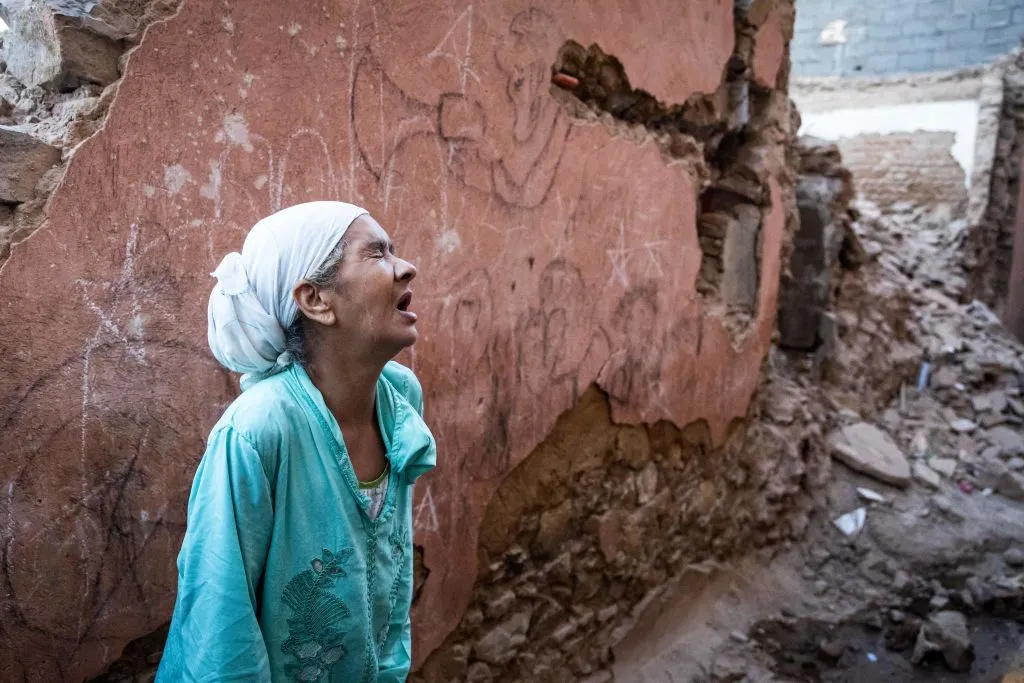A woman reacts standing in front of her earthquake-damaged house in the old city in Marrakesh on Sept. 9, 2023. A powerful earthquake that shook Morocco late Sept. 8 killed more than 1,000 people, the government said on Sept. 9, sending terrified residents fleeing their homes in the middle of the night.?w=200&h=150