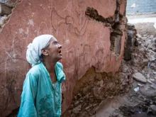 A woman reacts standing in front of her earthquake-damaged house in the old city in Marrakesh on Sept. 9, 2023. A powerful earthquake that shook Morocco late Sept. 8 killed more than 1,000 people, the government said on Sept. 9, sending terrified residents fleeing their homes in the middle of the night.