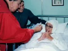 Mother María Berenice receives the Eucharist during a period of illness.