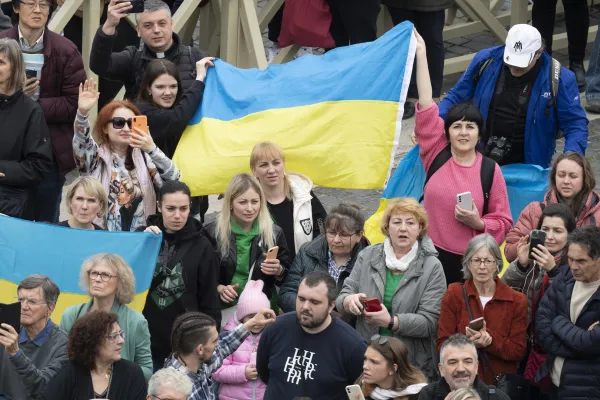 People wave Ukrainian flags during Pope Francis' Angelus address in St. Peter's Square March 19, 2023. Vatican Media