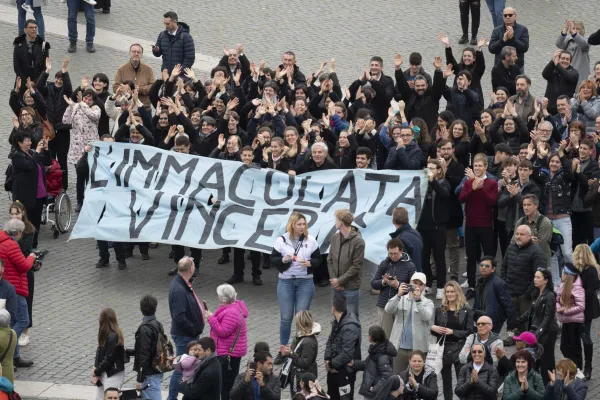 Members of the Casa di Maria ("House of Mary") community hold a banner that says in Italian, "The Immaculate Conception will Triumph," during Pope Francis' Angelus in St. Peter's Square on March 19, 2023. Vatican Media
