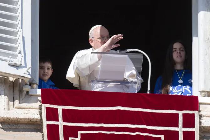 Pope Francis speaks alongside two children from Catholic Action at his Angelus address on Jan. 29, 2023