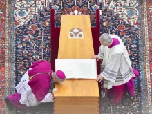 Archbishop Georg Ganswein (left), longtime personal secretary of Pope Benedict XVI, kisses the coffin of friend and mentor at his funeral on Jan. 5, 2023, at the Vatican.