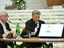 Cardinal Jean-Claude Hollerich (left), relator general of the Synod on Synodality, and Cardinal Mario Grech, secretary general of the Synod, at the Oct. 9, 2023, general congregation.
