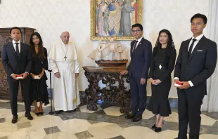 Pope Francis poses next to a miniature model of a ship with Madagascar's President Andry Nirina Rajoelina and his family in the Vatican's apostolic palace on Aug. 17, 2023. Vatican Media.