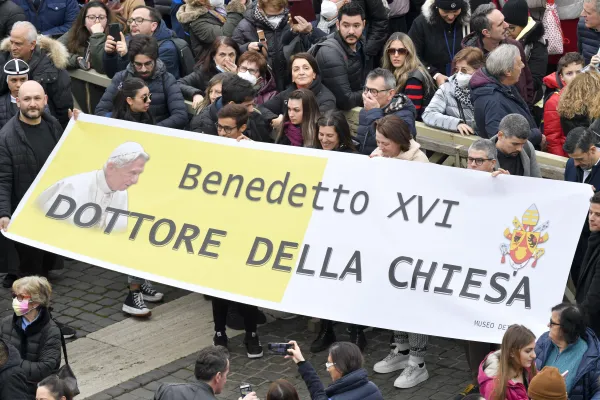 At the pope's Angelus address on Jan. 6, 2023, some pilgrims held up a banner calling for the late Benedict XVI to be named a doctor of the Church. Vatican Media