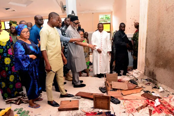 Bishop Jude Arogundade (in white, third from right) looks on as Ondo State governor Rotimi Akeredolu (third from left) is shown the bloodstained floor after an attack by gunmen at St. Francis Xavier Catholic Church in Owo, southwest Nigeria, on June 5, 2022. AFP via Getty Images