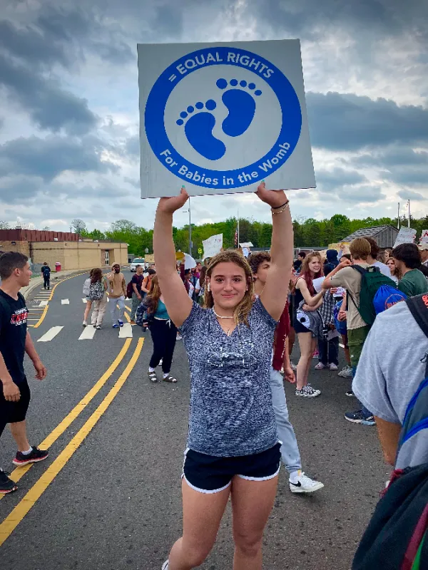 Nichole Pagano, 16, stands holding a pro-life sign at an unsanctioned pro-abortion rally that occurred at Hunterdon Central Regional High School May 16, where she was verbally and physically harassed while having her sign vandalized. Vanessa Pagano.