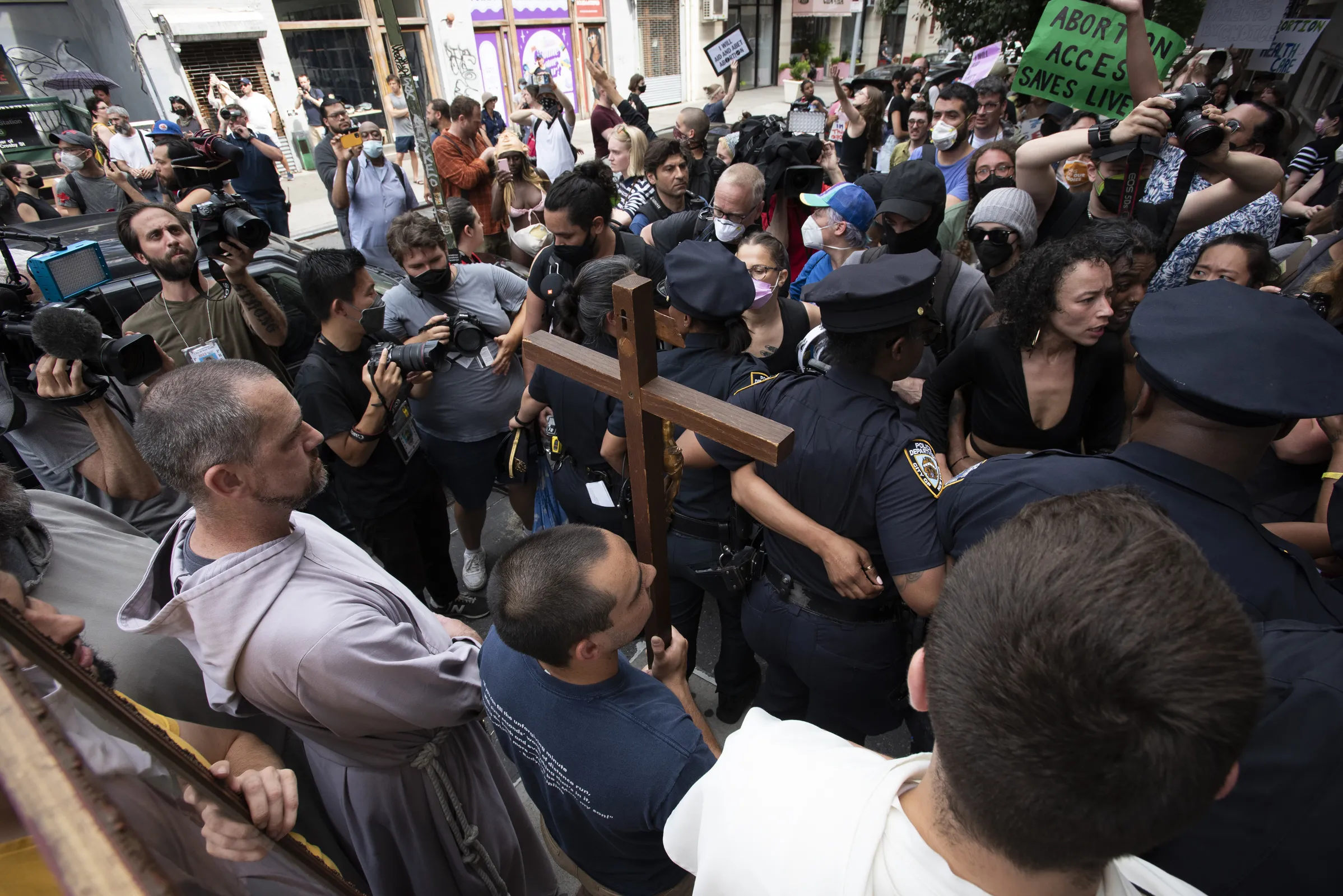 Father Fidelis Moscinski (lower left, standing behind the cross), a well-known pro-life activist and priest of the Franciscan Friars of the Renewal (CFR) is seen during a tense standoff between pro-life and pro-abortion demonstrators in Lower Manhattan on July 2, 2022. The pro-life marchers were trying to reach a Planned Parenthood abortion clinic where they planned to hold a prayer vigil, and the pro-abortion demonstrators were trying to block their path.?w=200&h=150