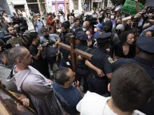Father Fidelis Moscinski (lower left, standing behind the cross), a well-known pro-life activist and priest of the Franciscan Friars of the Renewal (CFR) is seen during a tense standoff between pro-life and pro-abortion demonstrators in Lower Manhattan on July 2, 2022. The pro-life marchers were trying to reach a Planned Parenthood abortion clinic where they planned to hold a prayer vigil, and the pro-abortion demonstrators were trying to block their path.