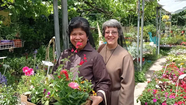 Sister Naomi Zimmermann (right) and Sister Maria David Magbanua, in a greenhouse. The two sisters of the Franciscan Sister of the Eucharist live in Jerusalem. Credit: Photo courtesy of Sister Naomi Zimmermann, FSE