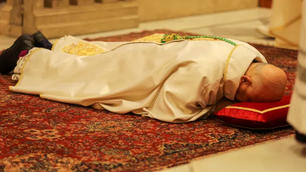 Father Hanna Jallouf, OFM, lies prostrate during the Mass of episcopal ordination while the litany of saints is sung Sept. 17, 2023. Credit: Photo courtesy of TEWK CENTRE