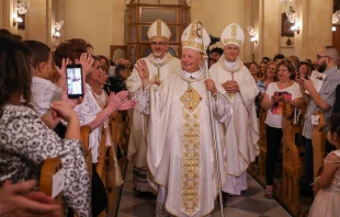 The new Bishop Hanna Jallouf, OFM, walks down the center aisle of St. Francis Church in Aleppo, Syrian, after his episcopal ordination, Sept. 17, 2023. Credit: Photo courtesy of TAWK CENTRE