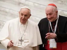Pope Francis arrives with Cardinal Marc Ouellet (R) of Canada for the opening of three-day Symposium on priesthood in the Paul VI hall at the Vatican on Feb. 17, 2022.