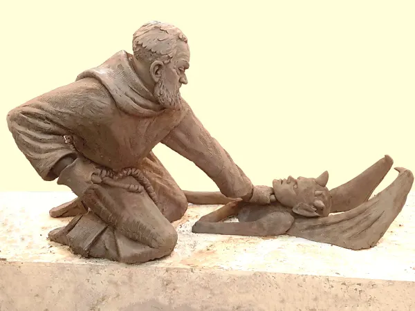 Artist Timothy P. Schmalz's sculpture illustrates Padre Pio strangling a demon and pushing him into nothingness, with one fist posed to strike. Courtesy of Timothy P. Schmalz
