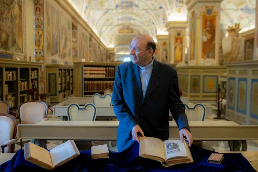 Father Mauro Mantovani, the prefect of the Vatican Library, shows journalists first-edition works by Blaise Pascal. Credit: Daniel Ibañez/CNA