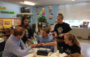 Former St. Peter Middle School students meet with patent attorneys from Foley and Lardner. Catholic Herald.