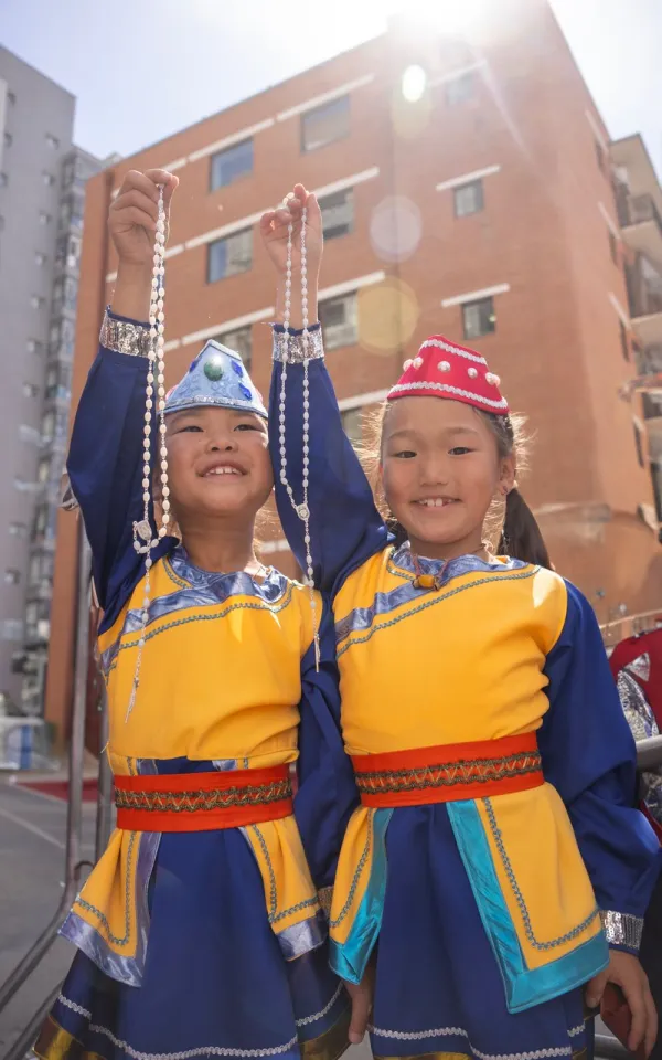 Two dancers who performed for Pope Francis upon his arrival at the apostolic prefecture in Ulaanbaatar, Mongolia, on Sept. 1, 2023, were proud to show the rosary beads the Holy Father gave them. Credit: Colm Flynn/EWTN News