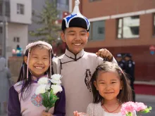Schoolchildren eagerly wait for the pope’s arrival outside of the apostolic prefecture on Sept. 1, 2023, in Ulaanbaatar, Mongolia, where Pope Francis will be staying for the duration of his four-day visit to the country.