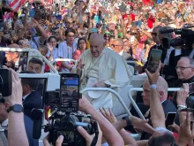 Pope Francis makes his way past crowds of thousands on his way to the World Youth Day welcoming ceremony in Lisbon, Portugal, Aug. 3, 2023.
