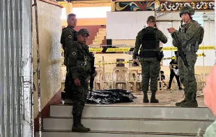 Military personnel stand guard at the entrance of a gymnasium while police investigators (background) look for evidence after a bomb attack at Mindanao State University in Marawi in the southern Philippines on Dec. 3, 2023. Credit: Merlyn Manos/AFP via Getty Images