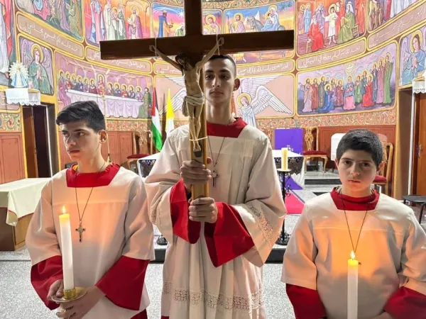Suhail Shadi Abu Dawod carries the cross during the Stations of the Cross celebration in Gaza's Latin parish during Lent 2024. "I am currently experiencing Lent in a different way than any other year before." he told CNA. Courtesy of Father Gabriel Romanelli