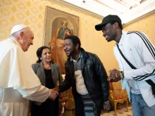 Pope Francis meets with refugees whom he helped to bring to Italy on his 85th birthday, Dec. 17, 2021.