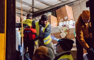 Polish Knights of Columbus unload a truck full of supplies for refugees fleeing Ukraine. Knights of Columbus