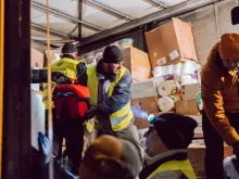 Polish Knights of Columbus unload a truck full of supplies for refugees fleeing Ukraine.