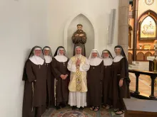 The Poor Clares of Perpetual Adoration from the Our Lady of Solitude Monastery in Tonopah, Arizona, accompanied by their local priest.