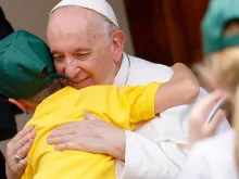 Pope Francis embraces a child during his meeting with participants in the Children's Train initiative at the Vatican on June 4, 2022.