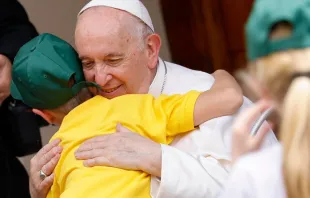 Pope Francis embraces a child during his meeting with participants in the Children's Train initiative at the Vatican on June 4, 2022. Vatican Media