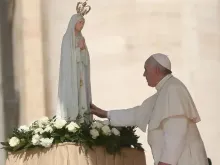 Pope Francis in front of a statue of Our Lady of Fatima on the feast day of Our Lady of Fatima.
