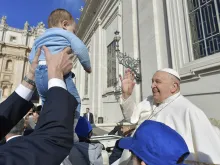 Pope Francis blesses a baby at his Wednesday general audience on March 20, 2024, in St. Peter’s Square at the Vatican.
