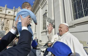 Pope Francis blesses a baby at his Wednesday general audience on March 20, 2024, in St. Peter’s Square at the Vatican. Credit: Vatican Media