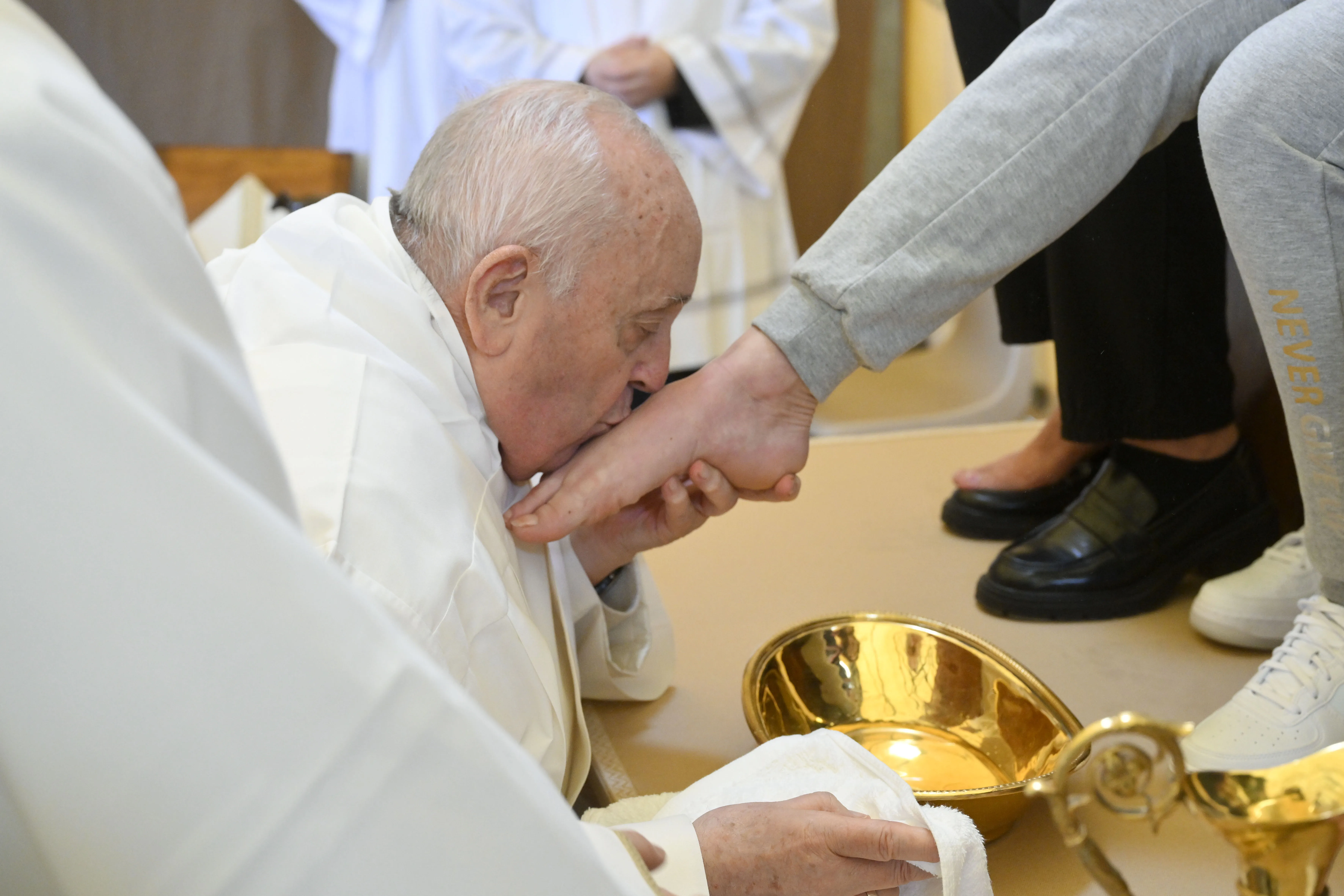 Pope Francis kisses the foot of one of the 12 women whose feet he washed at the Rebibbia Women’s Prison in Rome on Holy Thursday, March 28, 2024.?w=200&h=150